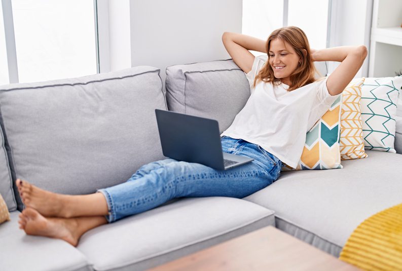 Parker-Heating-and-Air-Conditioning-woman-relaxing-on-couch-with-laptop